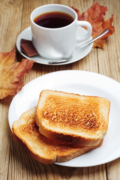 Toast and cup of coffee on a wooden table