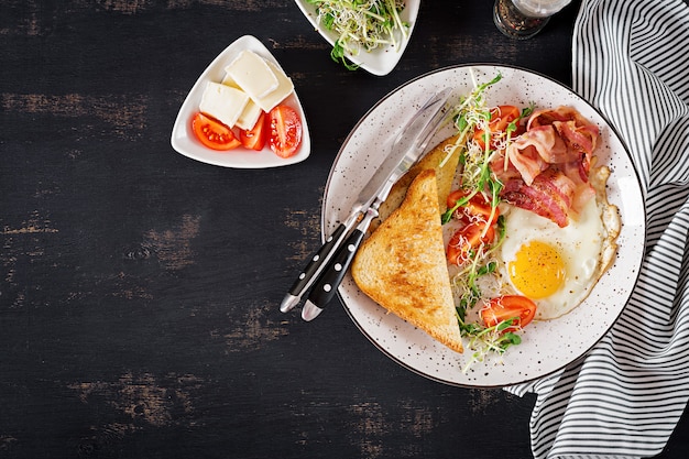 Photo toast, egg, bacon and tomatoes and microgreens salad