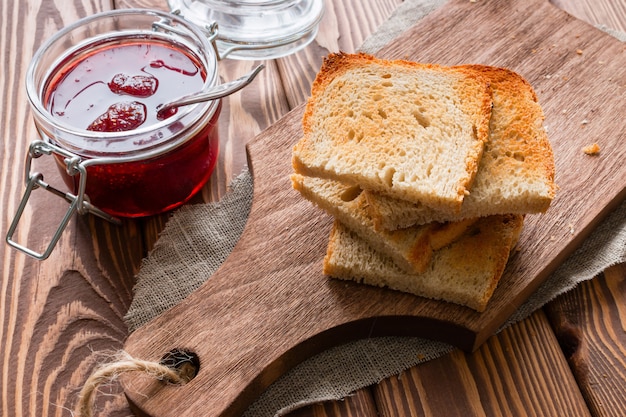 Toast stacked next to a jar of jam