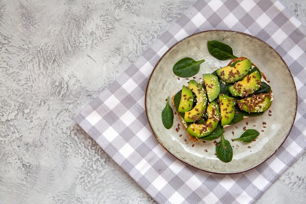 Toast with avocado cottage cheese spinach sesame seeds flax seeds Healthy food rich in fiber trace elements omega acids unsaturated lipids