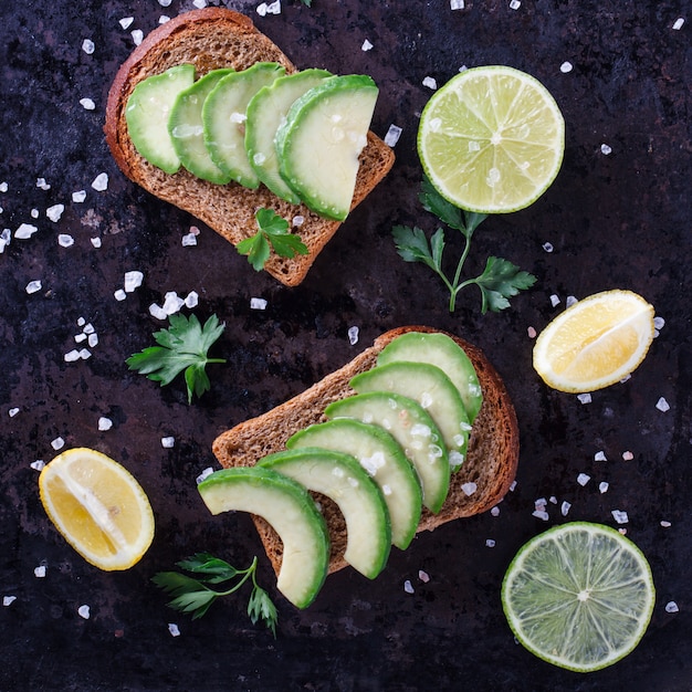 Toast with avocado on rye bread with parsley and salt 