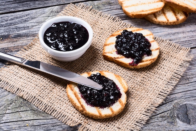 Toast with blueberry on rustic wooden background