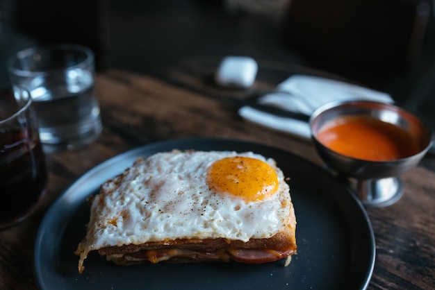 Toast with cheese and sausage covered with fried egg