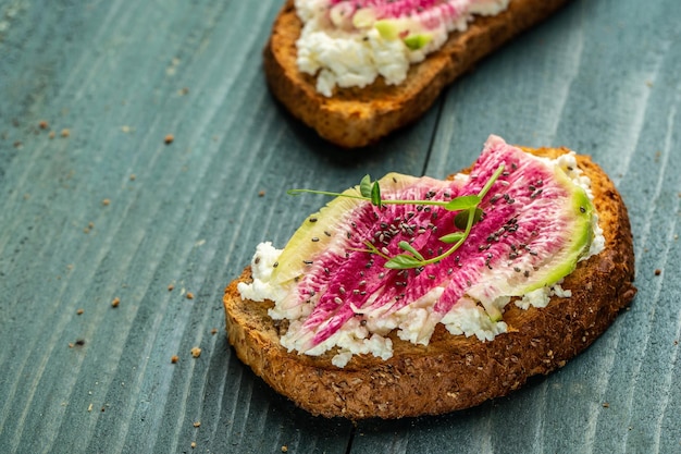 Toast with chia seeds with sliced watermelon radish or chinese daikon cottage cheese and microgreen freeze motion banner catering menu recipe