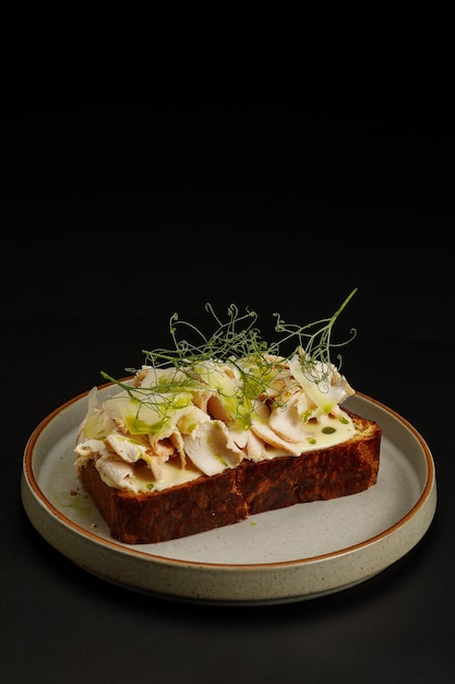 Toast with chicken fillet served with herbs on top