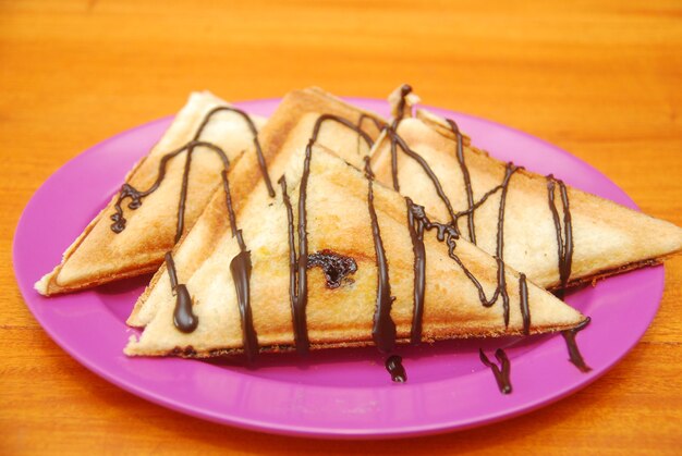 Photo toast with chocolate topping served on a wooden table