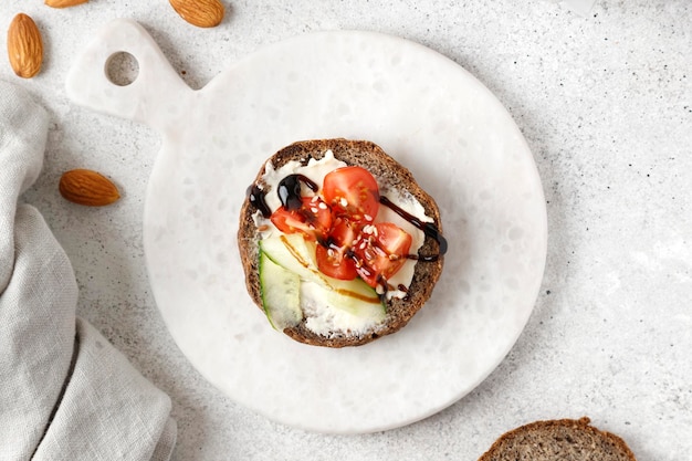 Toast with cream cheese tomato and sliced cucumber on wholemeal bread Bruschetta sandwich