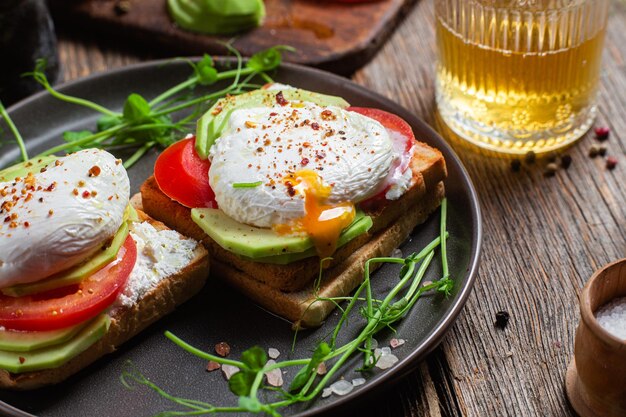 Toast with poached egg tomatoes and avocado Healthy breakfast