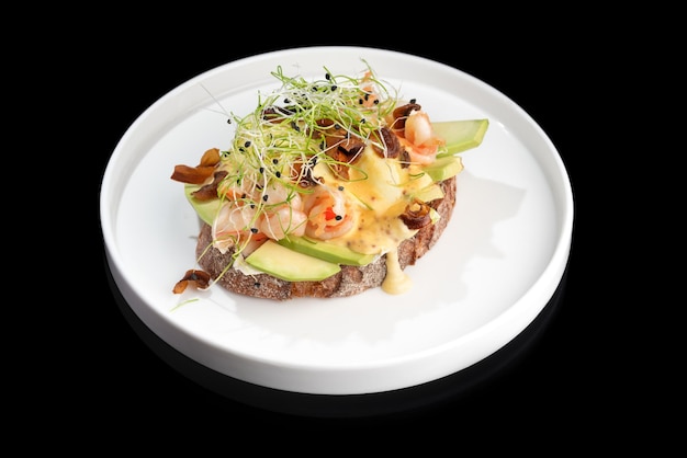 Toast with shrimp prawns avocado and poached egg