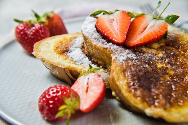 Toast with strawberries and maple syrup. 