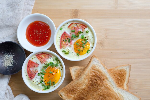 Toasted bread and cups of baking egg