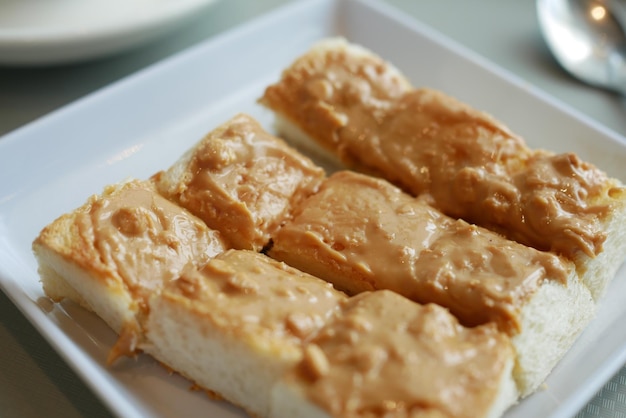 Toasted bread with peanut butter on a plate