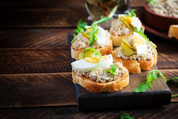 Toasted bread with a salted codfish mousse on wooden cutting board