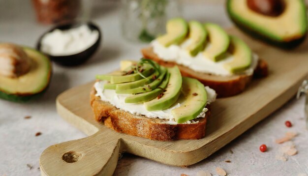 Toasted bread with with cream cheese and avocado on table Delicious sandwich Tasty snack