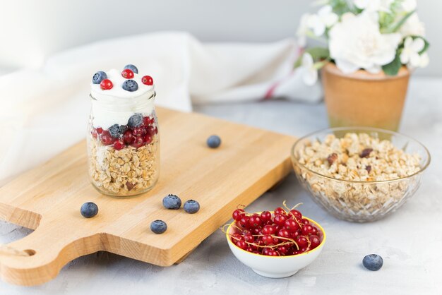 Toasted muesli yogurt and berries in glass jar