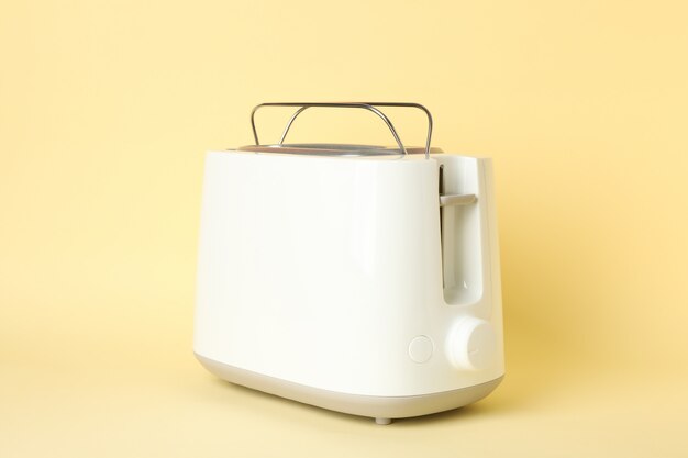 Toaster for bread on beige background, space for text