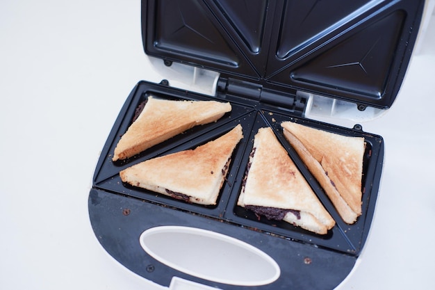 Photo toaster with toasted bread and chocolate in a white kitchen