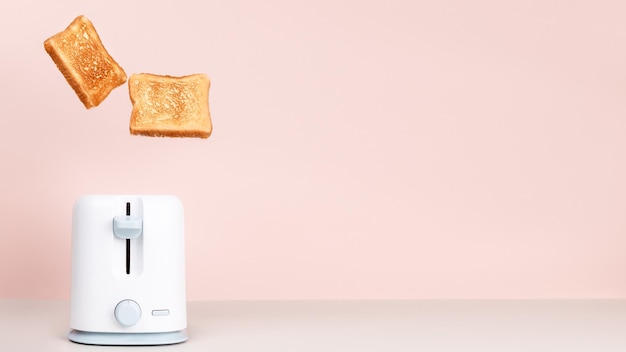 Toasts jumping out of white toaster Levitation food Fresh morning meal Delicious breakfast concept