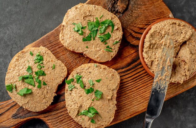 Toasts with beef and pork pate on stone background