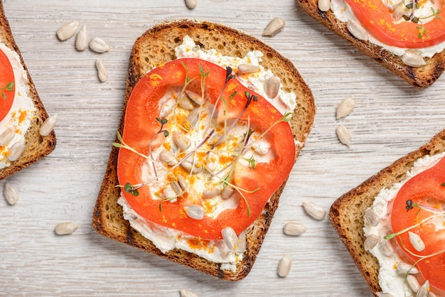 Toasts with cream cheese, pepper, microgreens and sunflower seeds