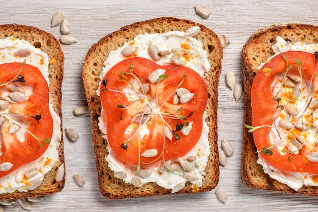 Toasts with cream cheese, pepper, microgreens and sunflower seeds