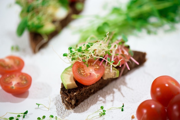 Toasts with microgreens. Hand holds a healthy toast. Healthy food concept. Super food.