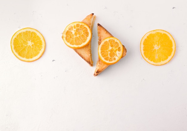 Photo toasts with orange jam on white top view