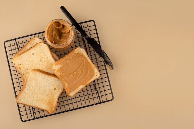 toasts with peanut butter on the black grid