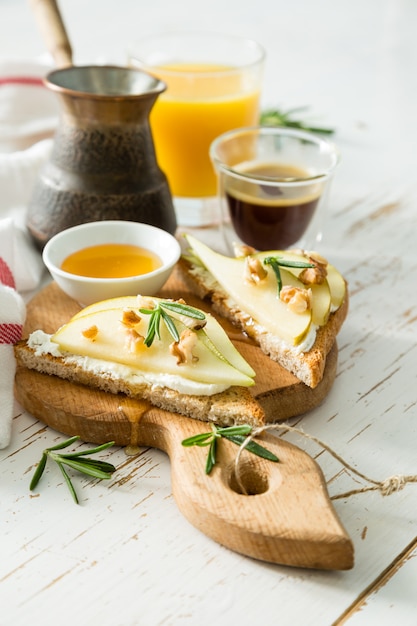 Toasts with pear, goat cheese and walnuts, honey, rosemary