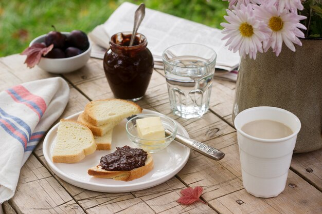 Toasts with plum chocolate jam and cocoa. Breakfast in the garden. Rustic style