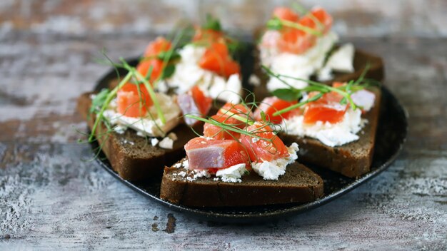 Toasts with salmon and white cheese on a plate. keto diet. keto toasts