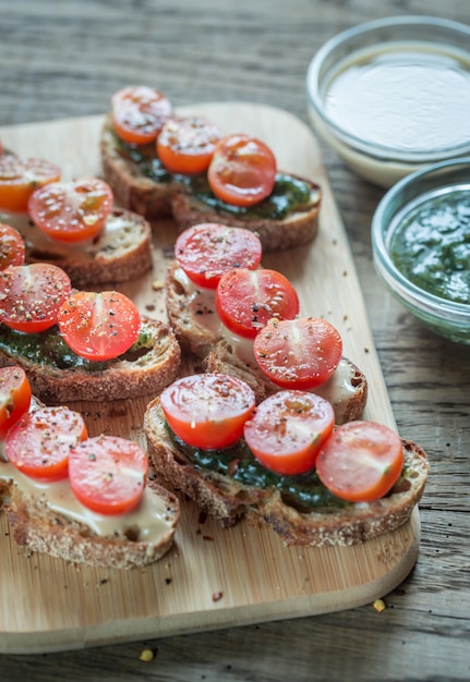 Toasts with tahini and mint sauce and cherry tomatoes