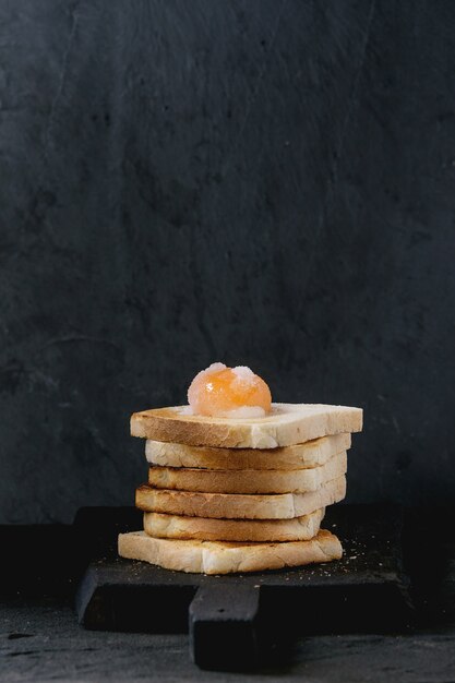 Toasts with yolk over black