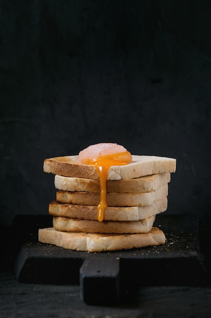 Toasts with yolk over black