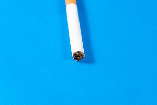 タバコのタバコは青色の背景でクローズアップ