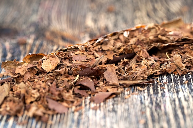 Tobacco from a crumbling cigarette on the board