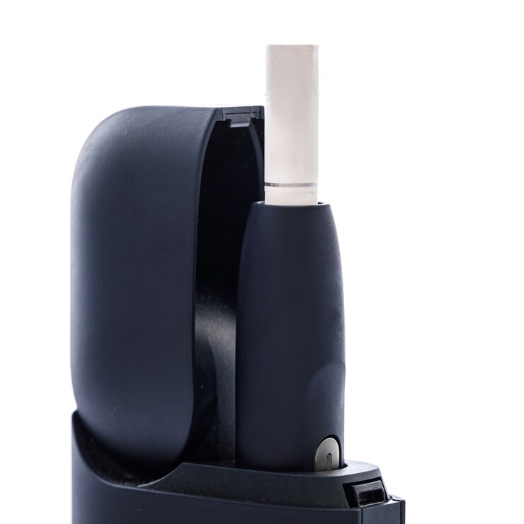 Photo tobacco heating system on white surface. alternative of traditional cigarettes