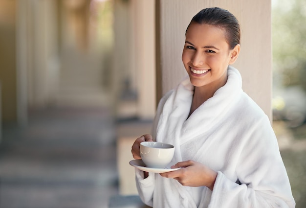 Today its all about me Shot of a young woman drinking a cup of coffee at the day spa