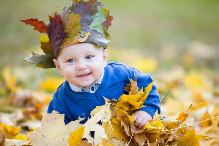 Toddler in the autumn leaves Beautiful little baby in yellow maple foliage1