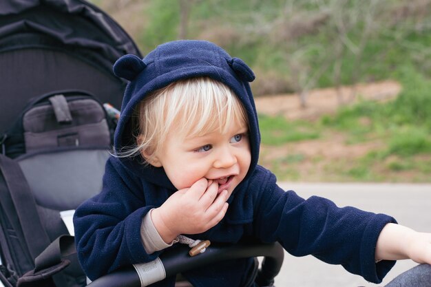 Toddler blond baby boy in a pram