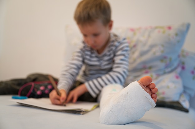 Toddler boy with plaster on his leg