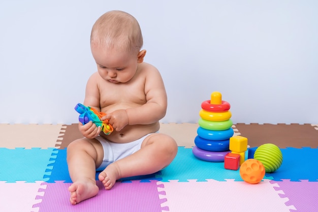 Toddler child playing with modern toy pop it