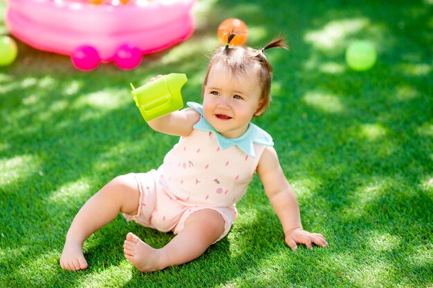 Toddler girl playing outdoor with the toys