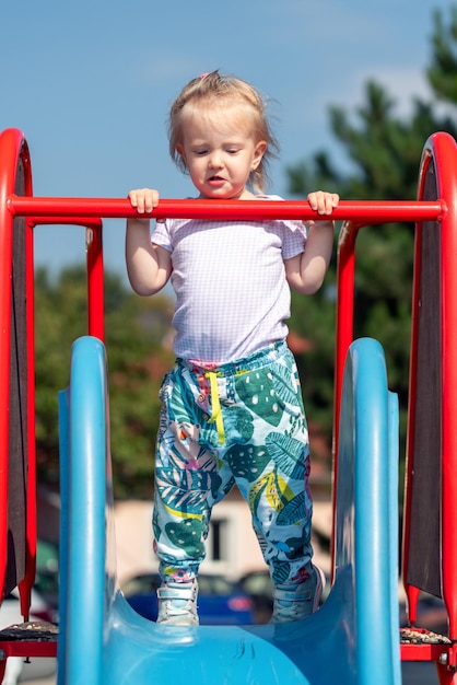 Toddler girl playing on slide