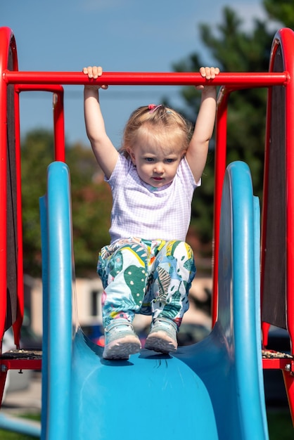 Toddler girl playing on slide