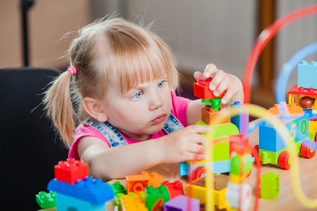 Toddler girl with colorful toys