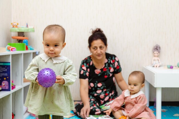 Photo toddler holding rubber ball