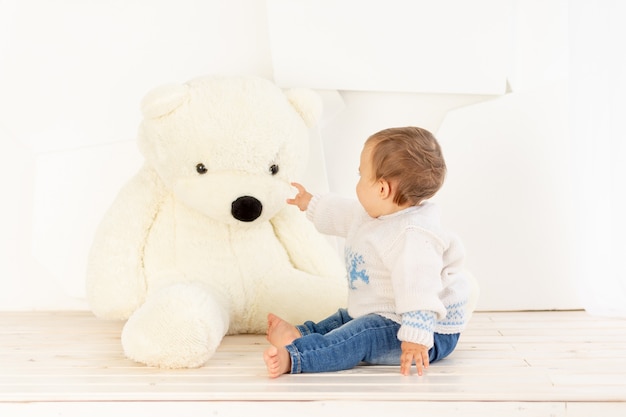 toddler playing with teddy bear