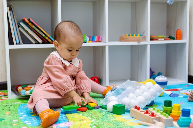 Toddler playing with wooden shapes