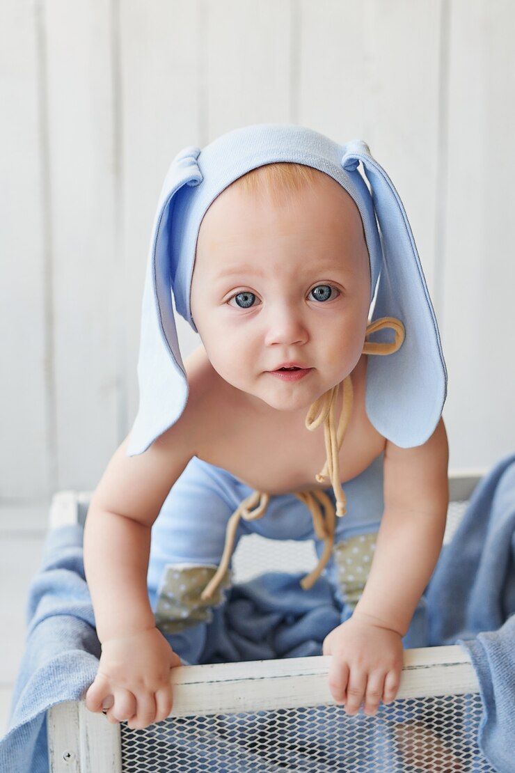 toddler with bunny ears in the crib
